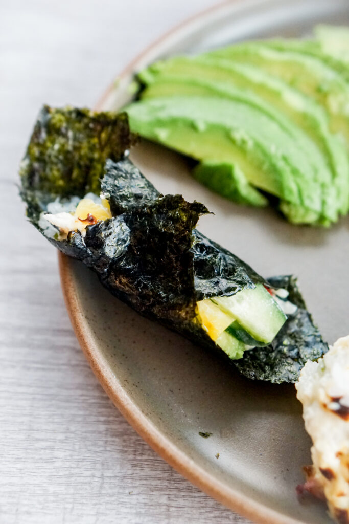 Closeup of sushi bake wrapped in seaweed.
