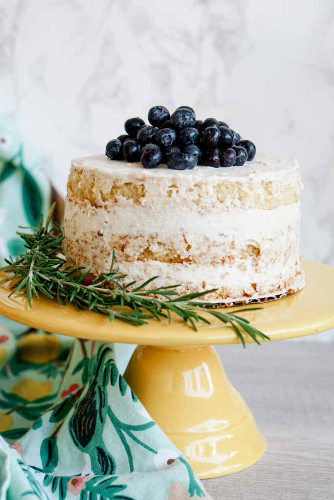 6" three layer lemon naked cake with blueberries on top and rosemary on the side