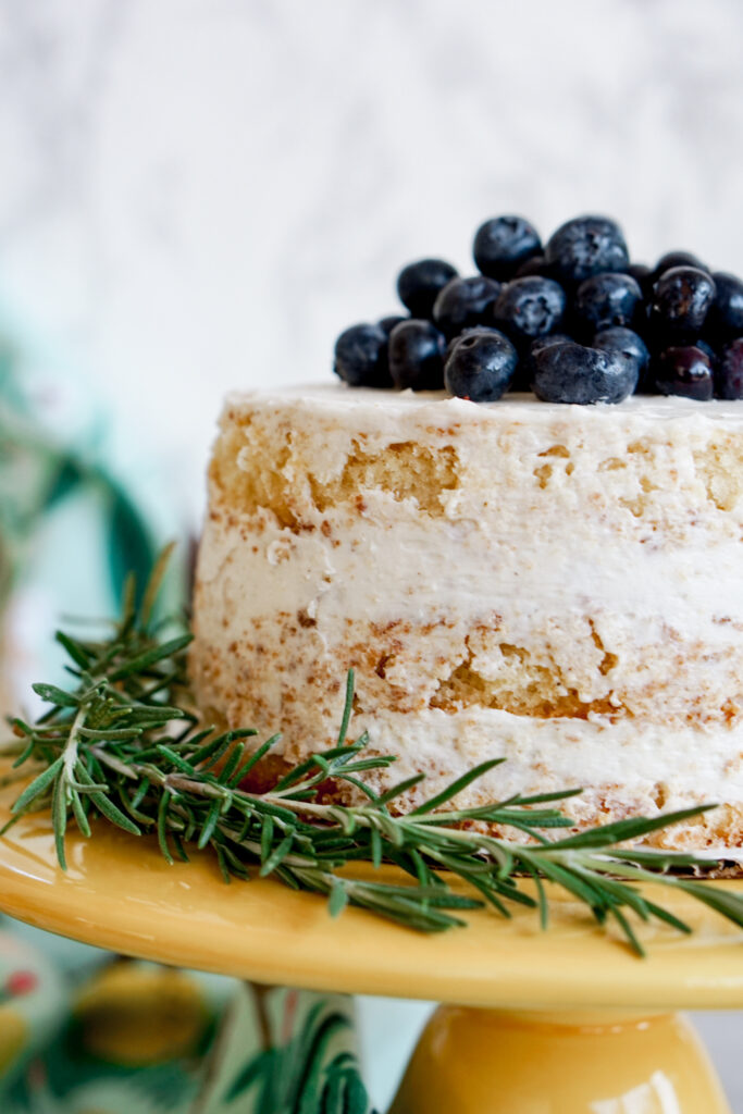 6" three layer lemon naked cake with blueberries on top and rosemary on the side