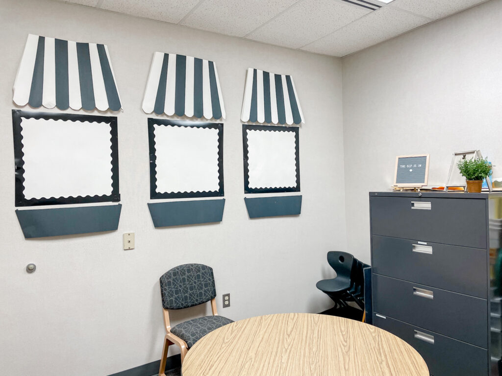 classroom decor featuring striped black and white faux awning and window boxes