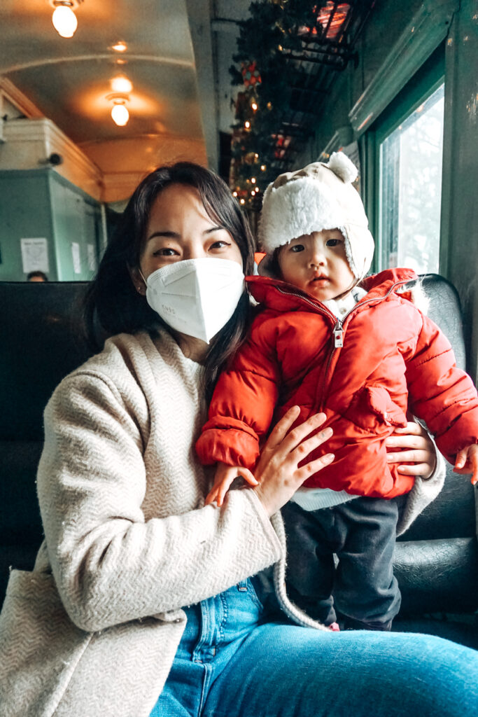 Asian mom and baby on the Yuletide Express train