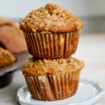 closeup shot of two kinako banana muffins stacked on top of each other